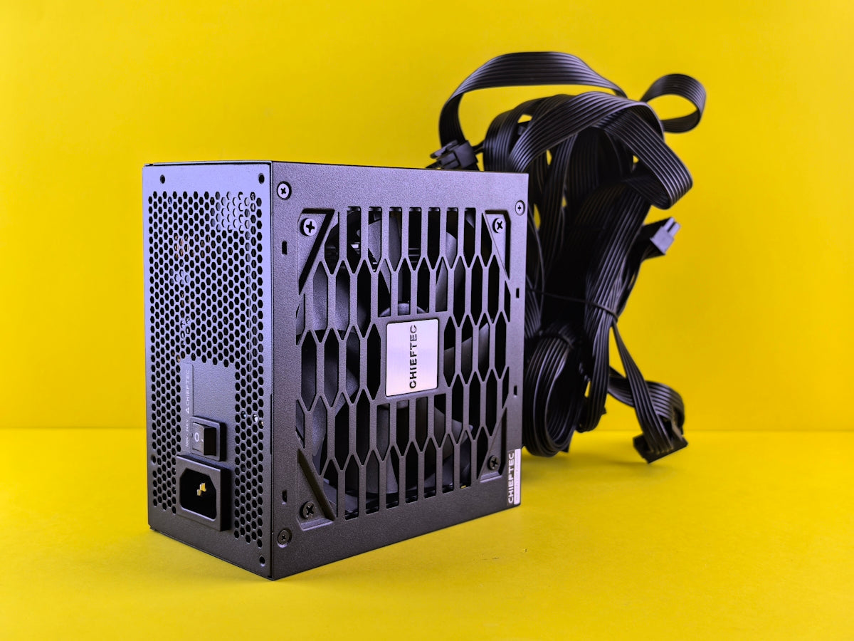 A black computer case sitting on top of a yellow surface